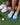 women with blue Balega socks on green grass. Golf equipment around socks. 